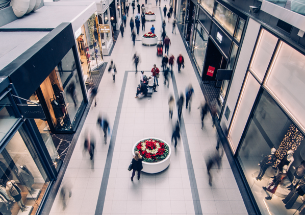 People walking through a mall hallway